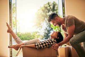 Shot of a young couple having fun while moving into their new place